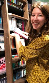 Sophie on ladder in bookstore